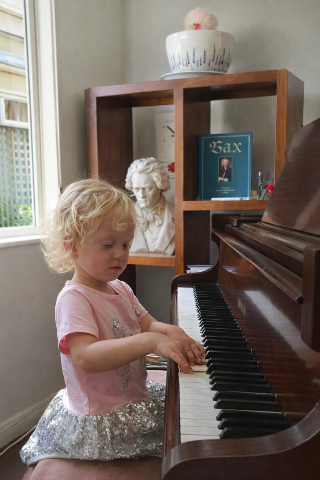 A young girl learning to play the piano